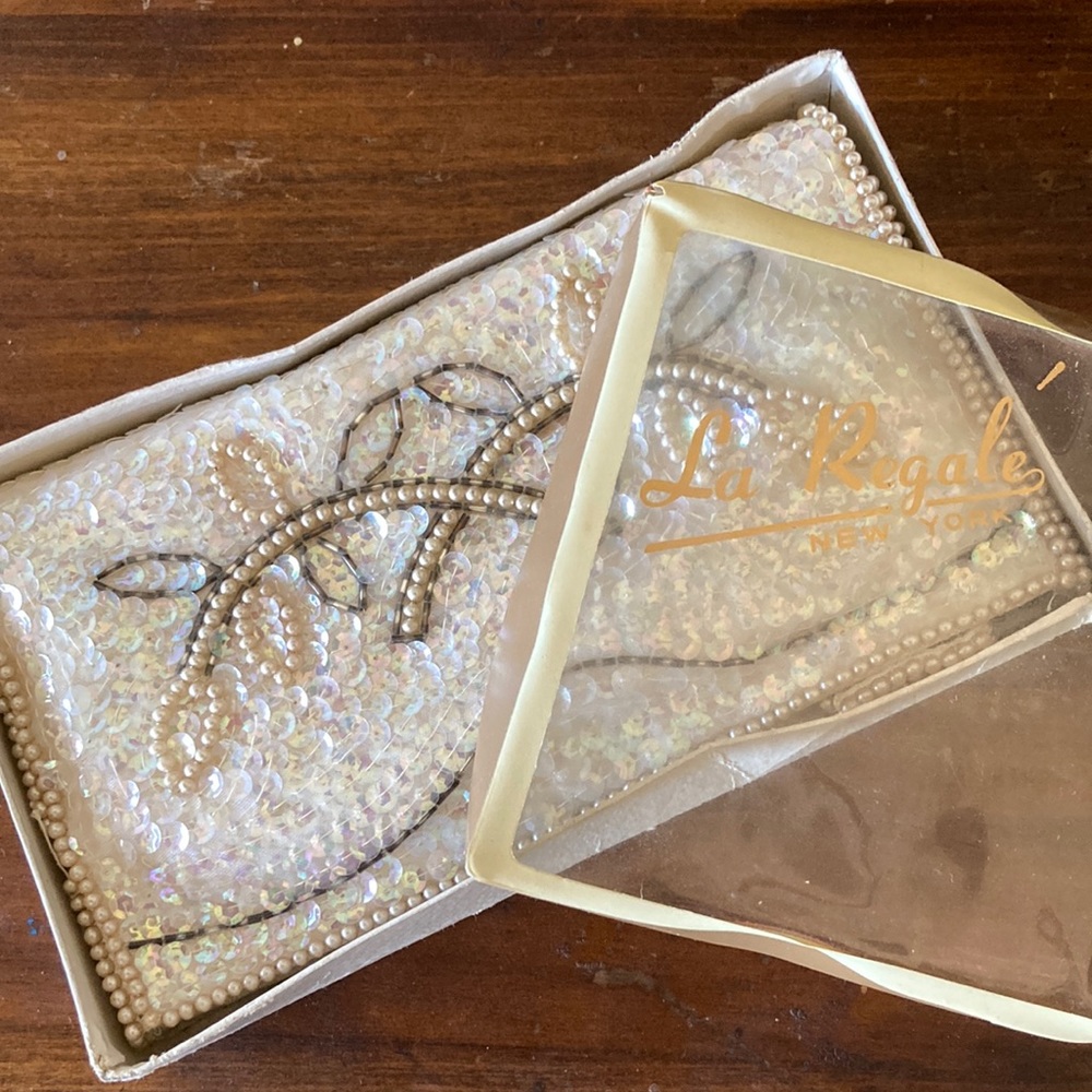 Beautiful antique clutch, still in original packaging with comb. La Regale